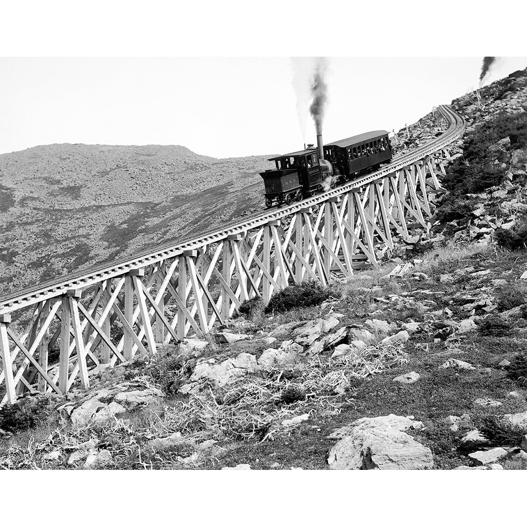 A vintage photograph showing a train descending Jacob's Ladder on Mount Washington in New Hampsire