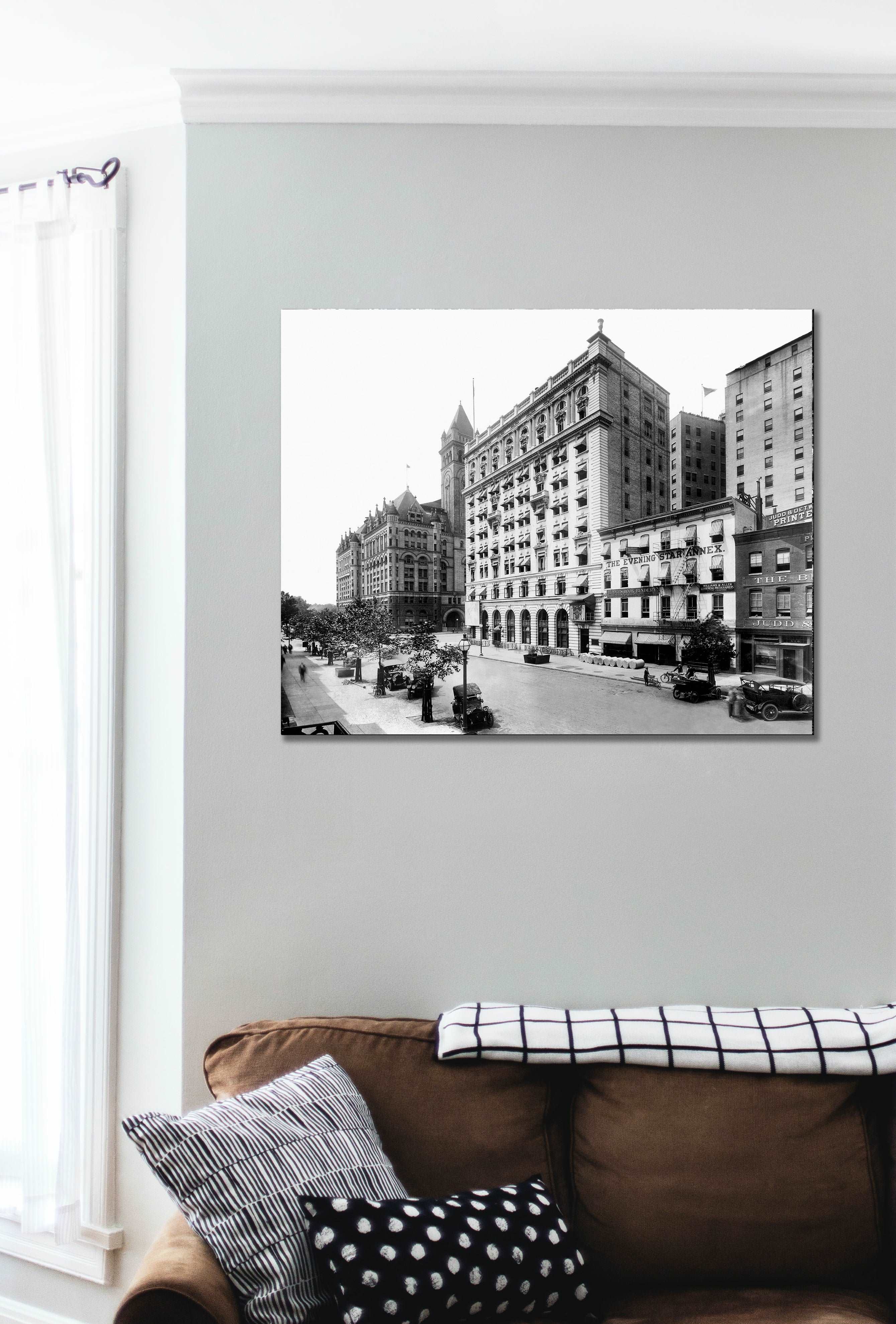 A section of a living room with a canvas print of vintage photograph on the wall