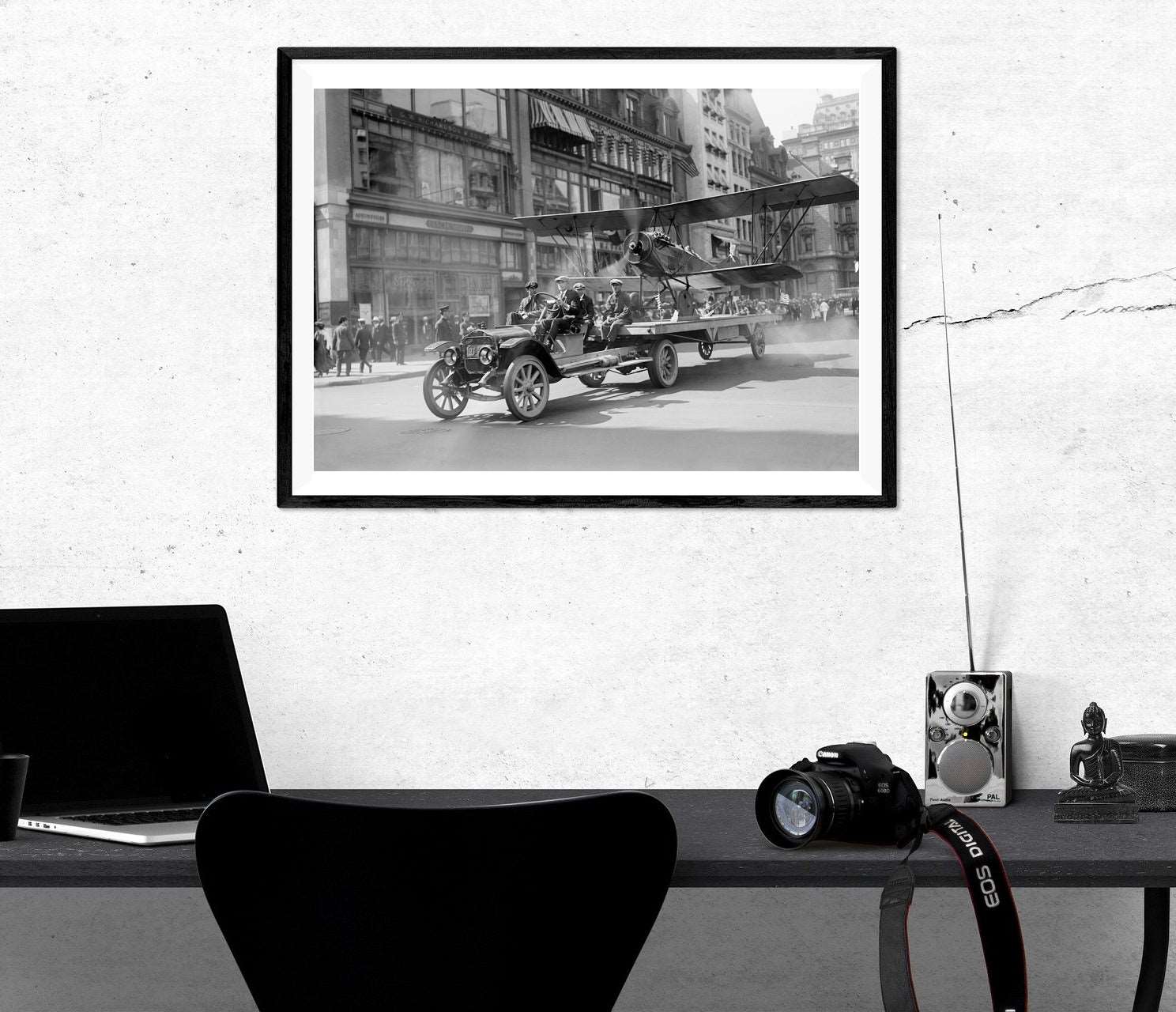 A photo of an office with a framed paper print of a vintage photograph of a 4th of July Parade