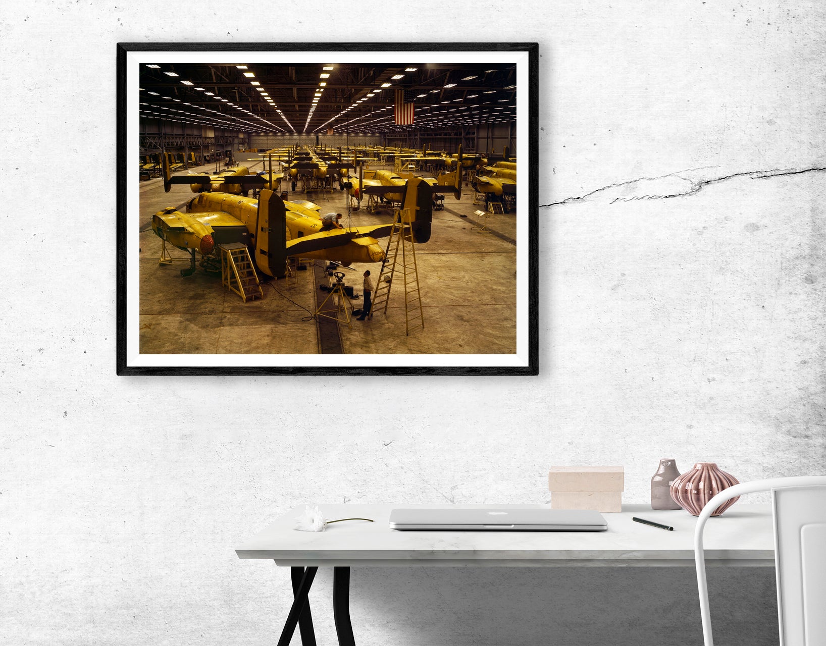 A digital rendering showing a framed paper print of vintage photography hanging on a white wall