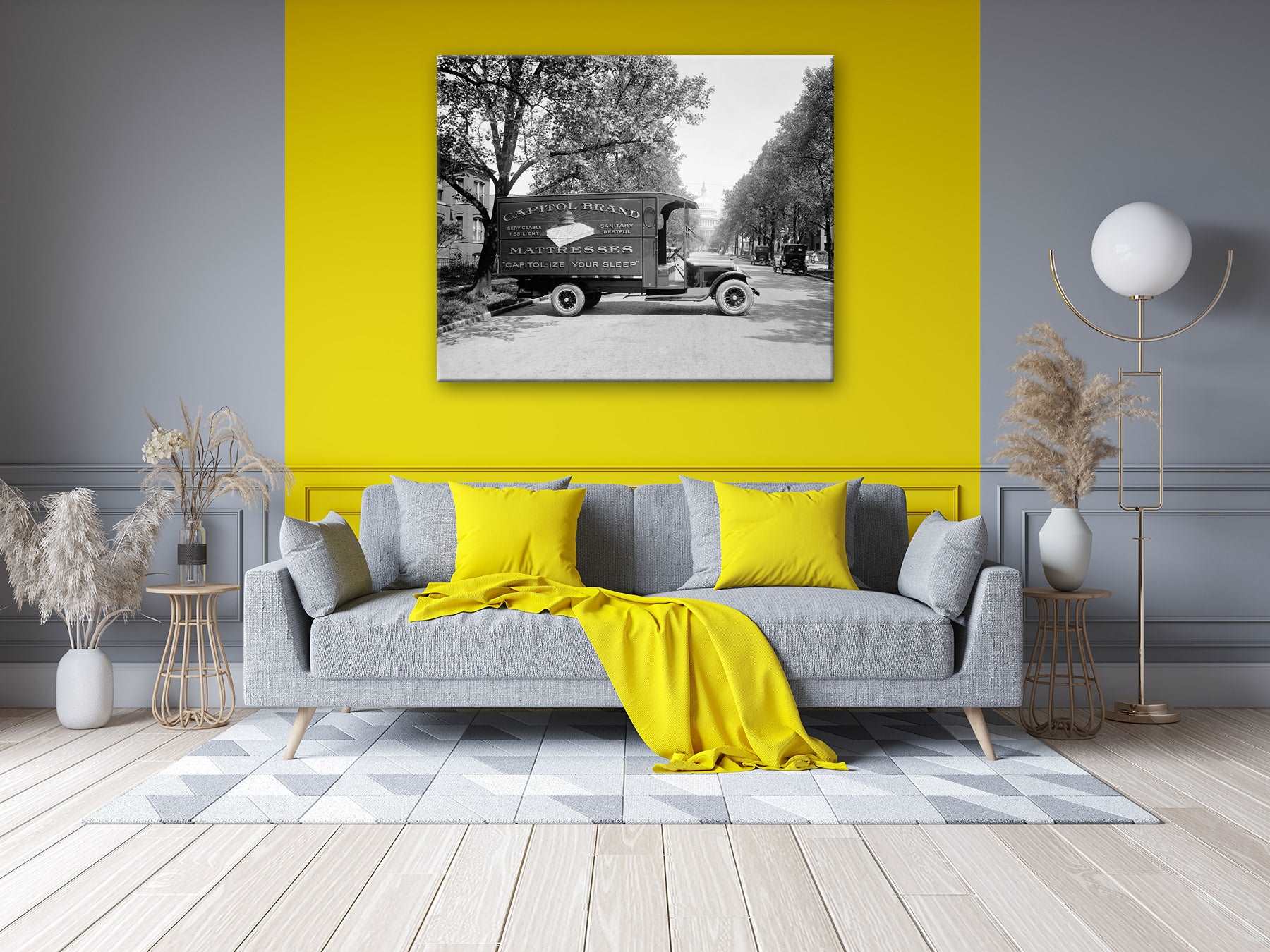 A canvas print of a vintage photograph of a Capitol Bedding Truck hanging on a yellow living room wall