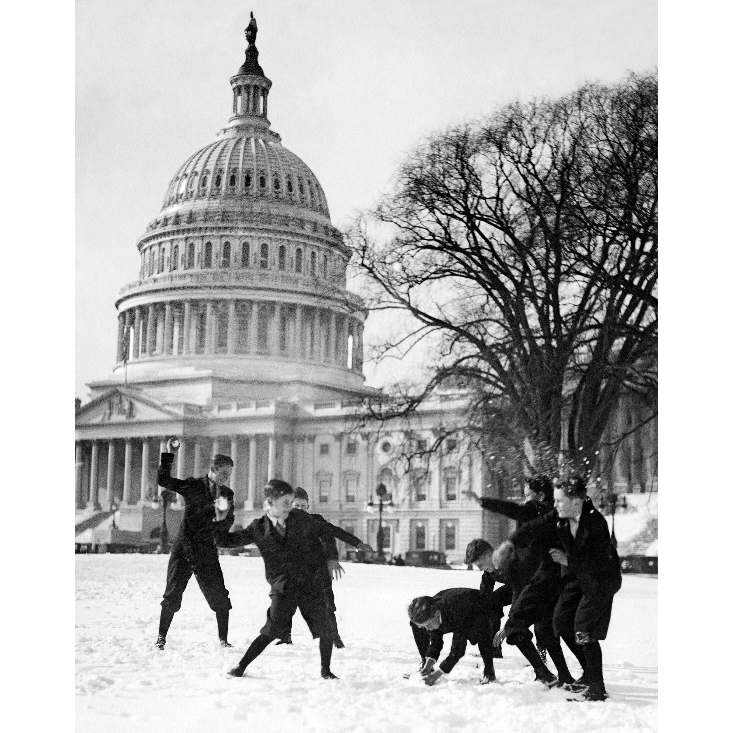 A vintage photograph of Capitol Pages having a snowball fight in front of the Capitol Building
