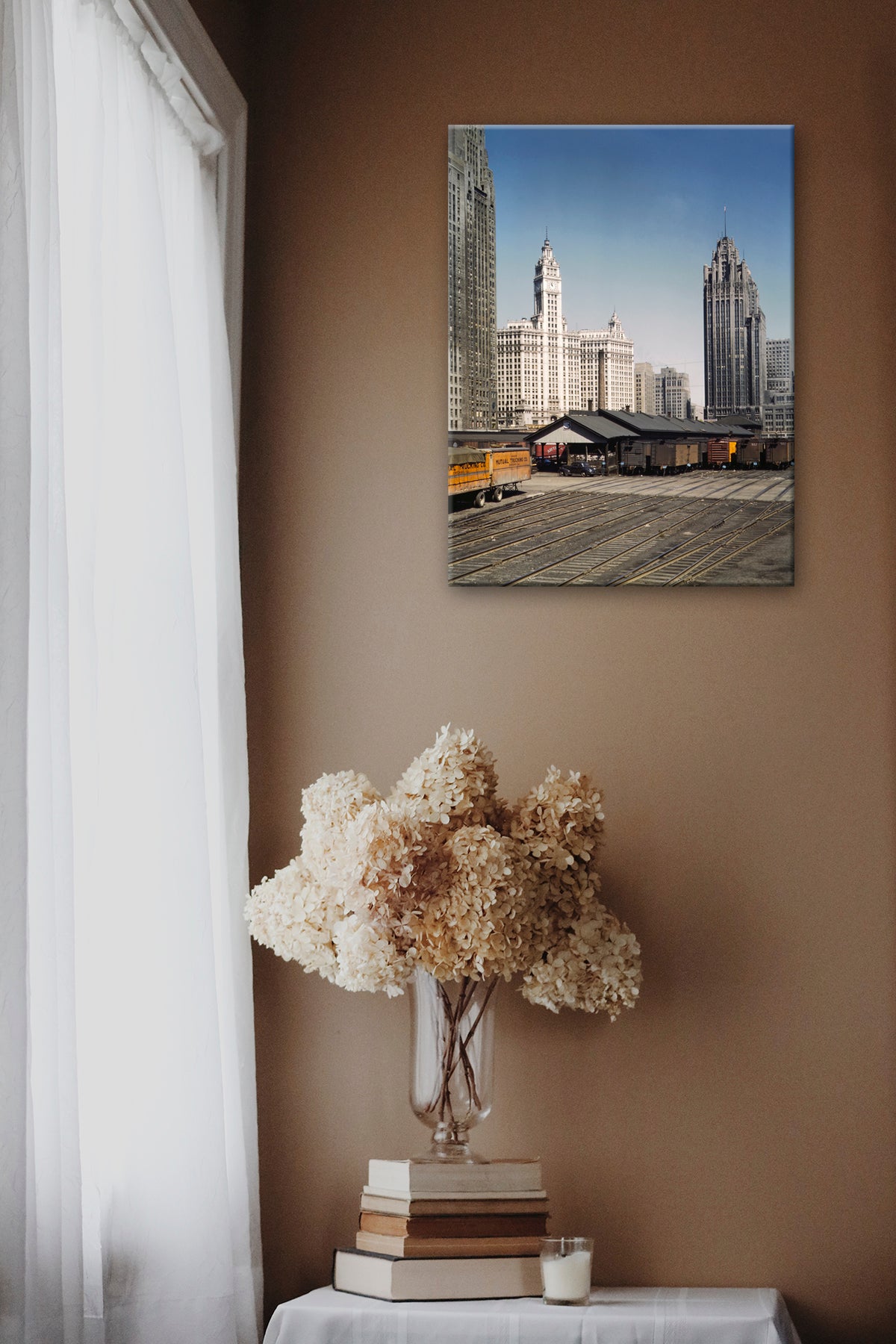 A canvas print of a vintage photograph of a Railroad Terminal hanging on a brown wall