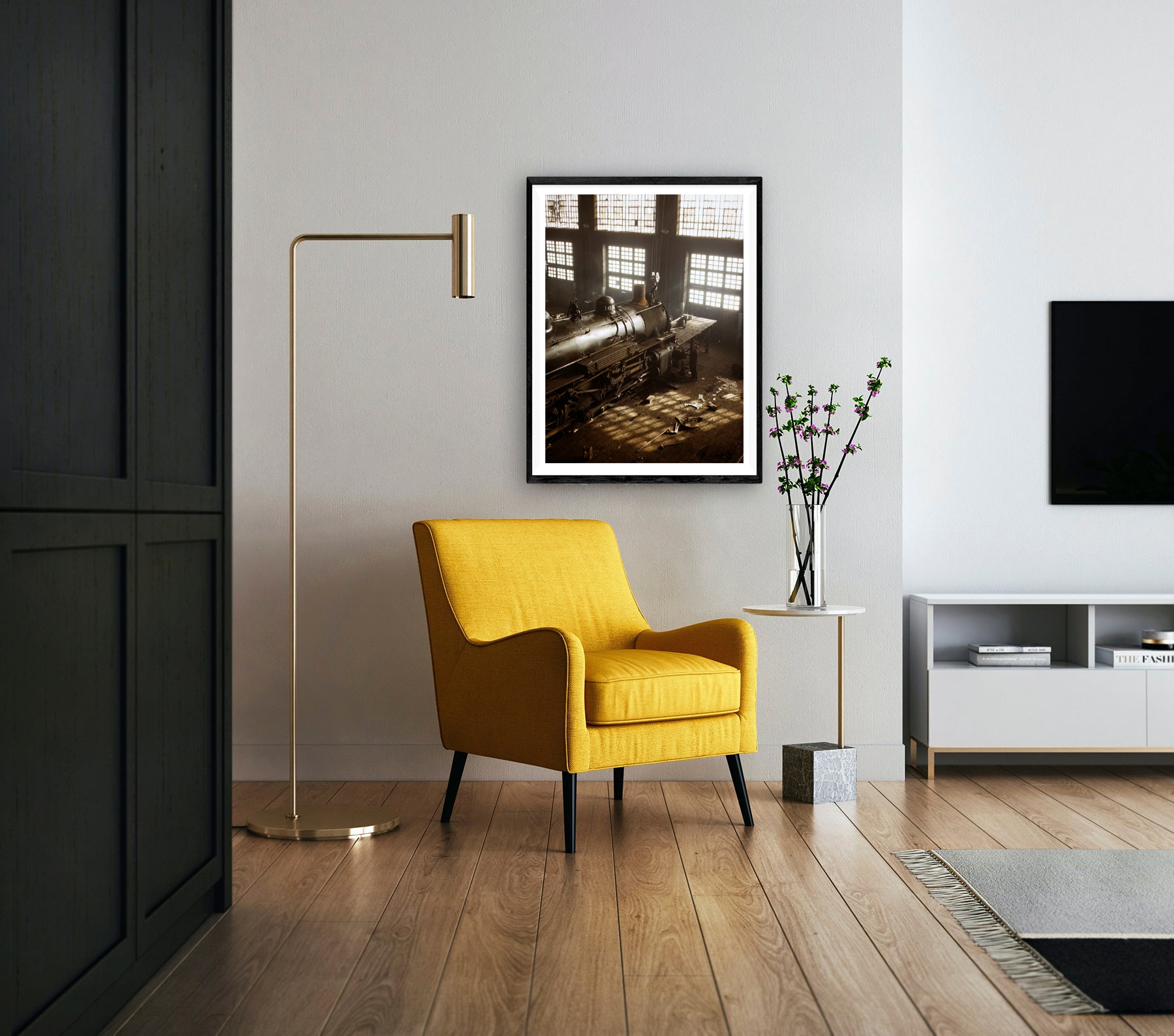 A framed paper print of a vintage photograph of Railroad Shops hangs in an elegant living room