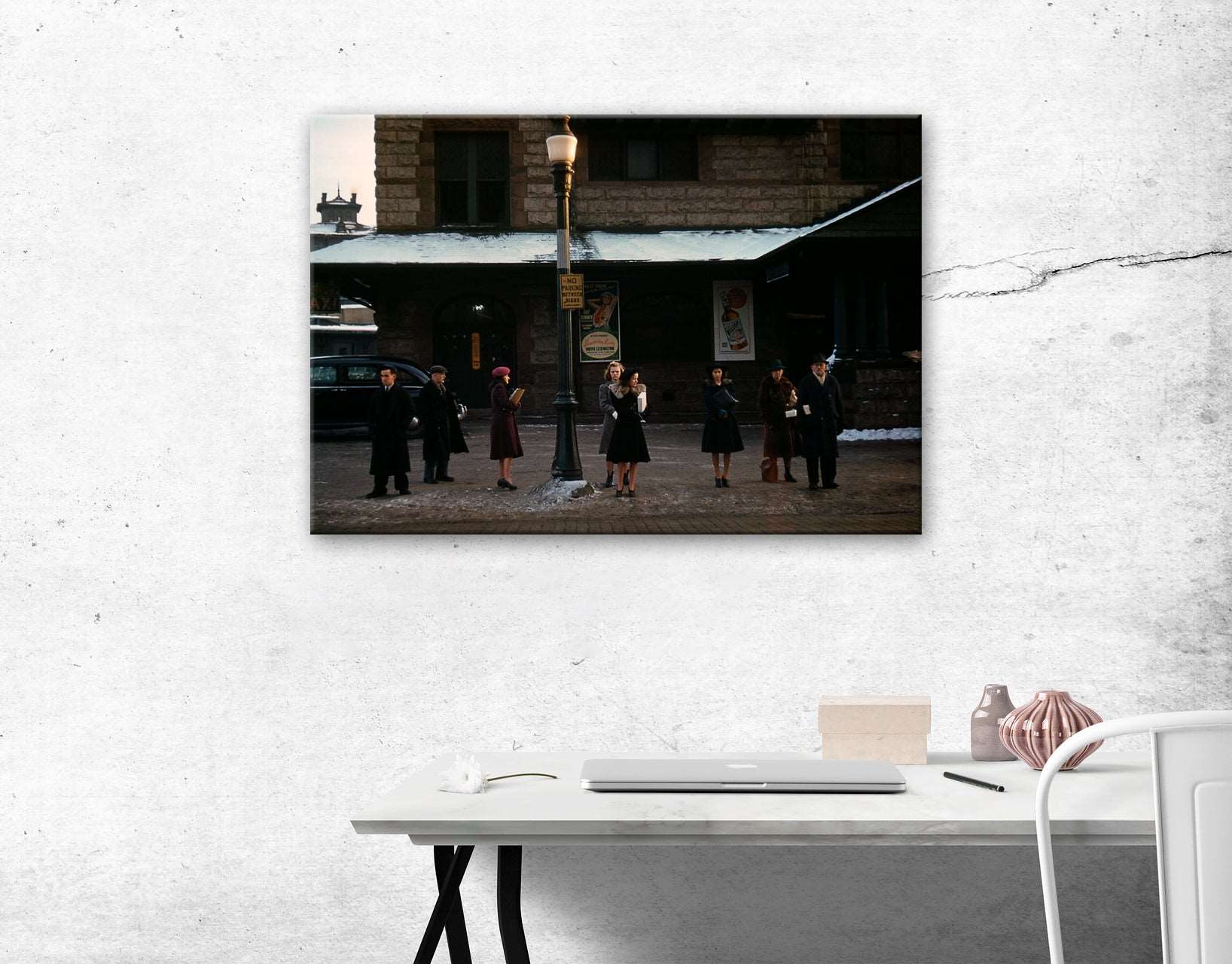A canvas print hanging on a white wall above a desk, featuring a vintage color photograph