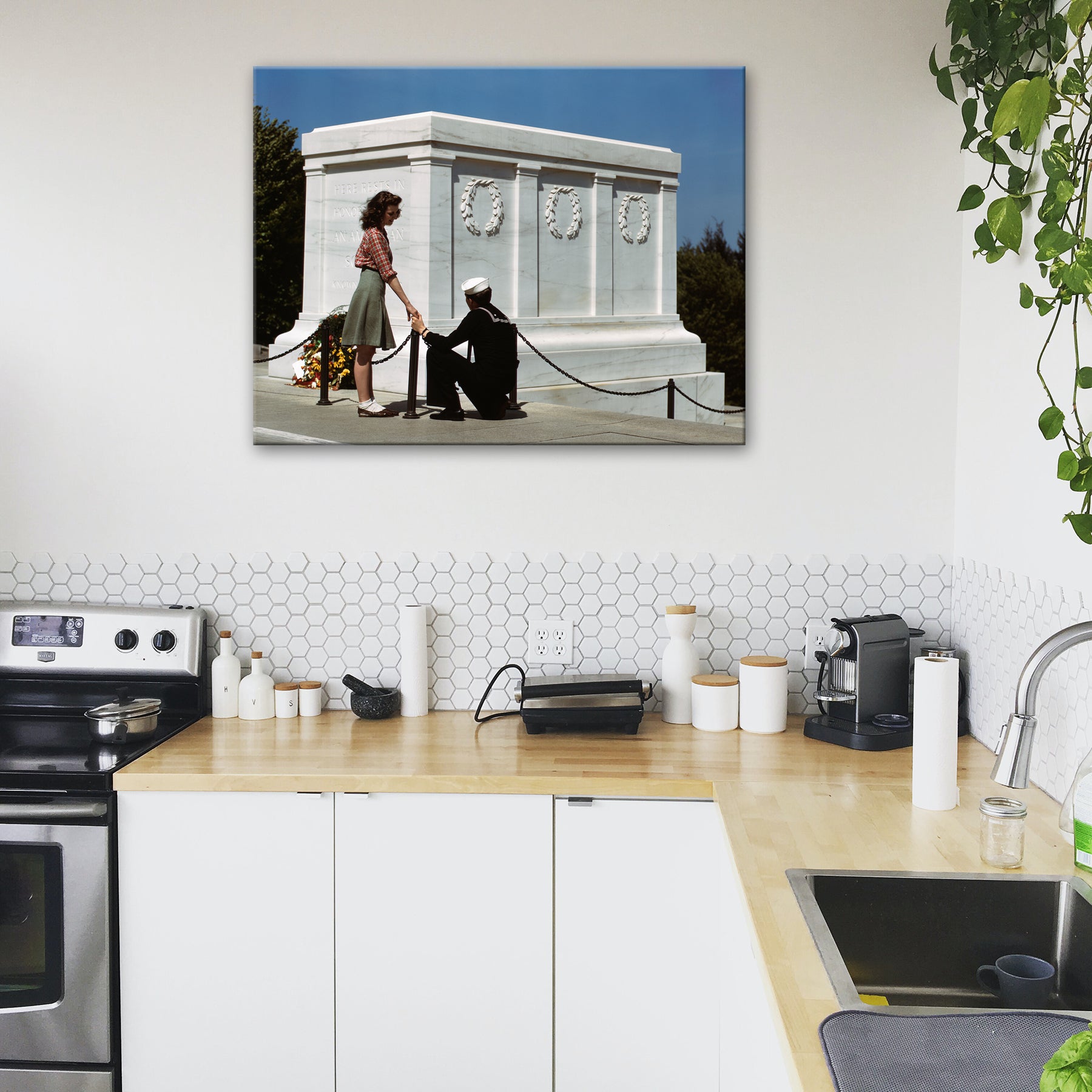 A photo of a kitchen with a stretched canvas print on the wall of a vintage color photograph