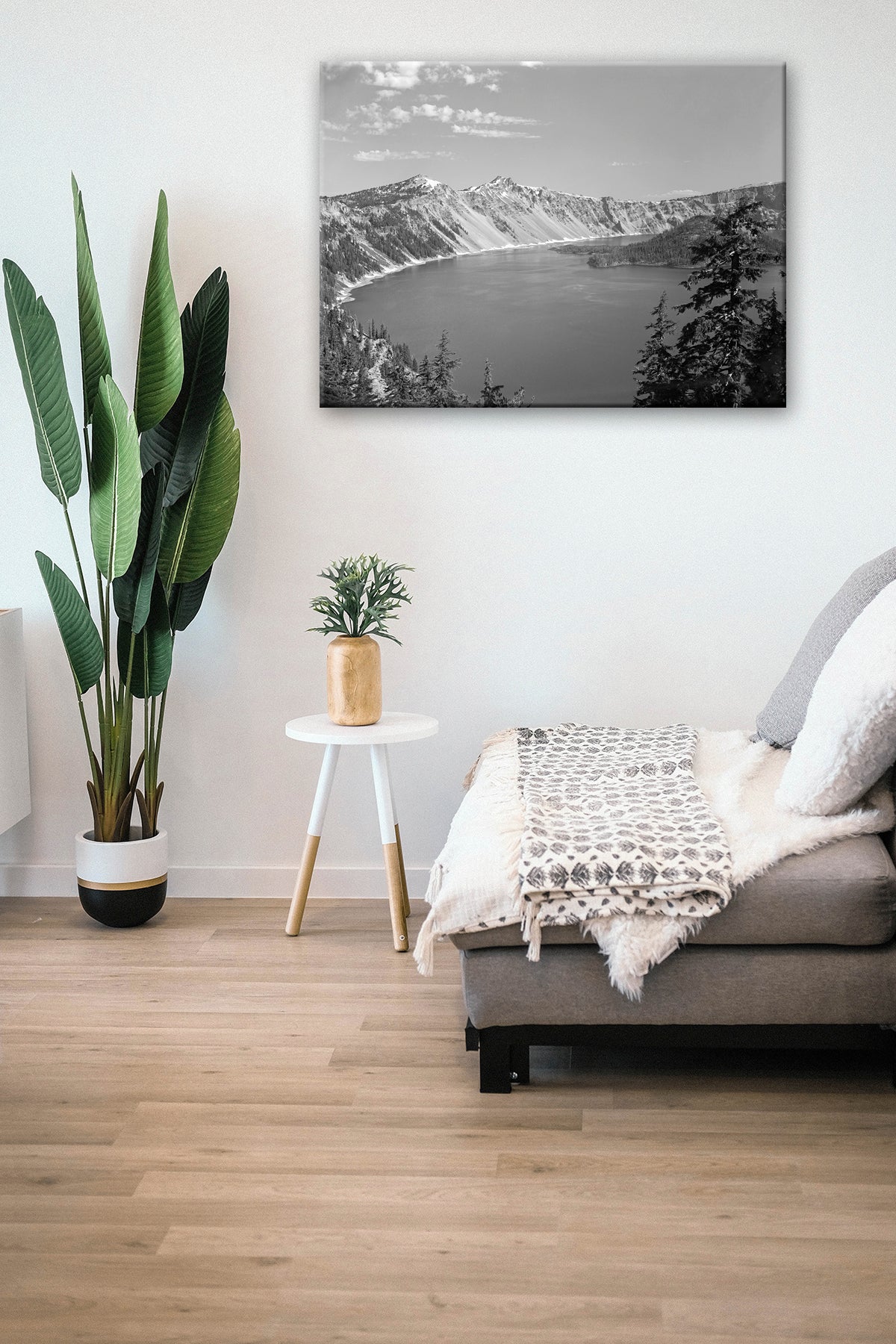 A living room with a canvas print of a vintage photograph of Crater Lake on the wall