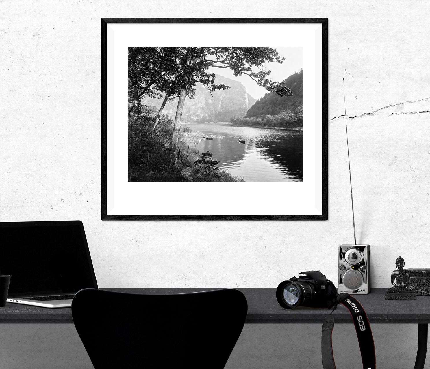 A paper print in a frame above a desk, featuring a vintage image of the Delaware Water Gap