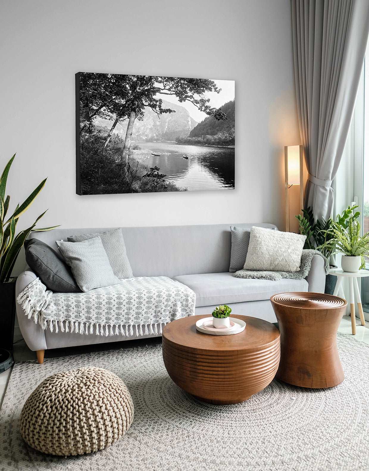 A neutral toned living room with a canvas print of a vintage photograph of the Delaware Water Gap