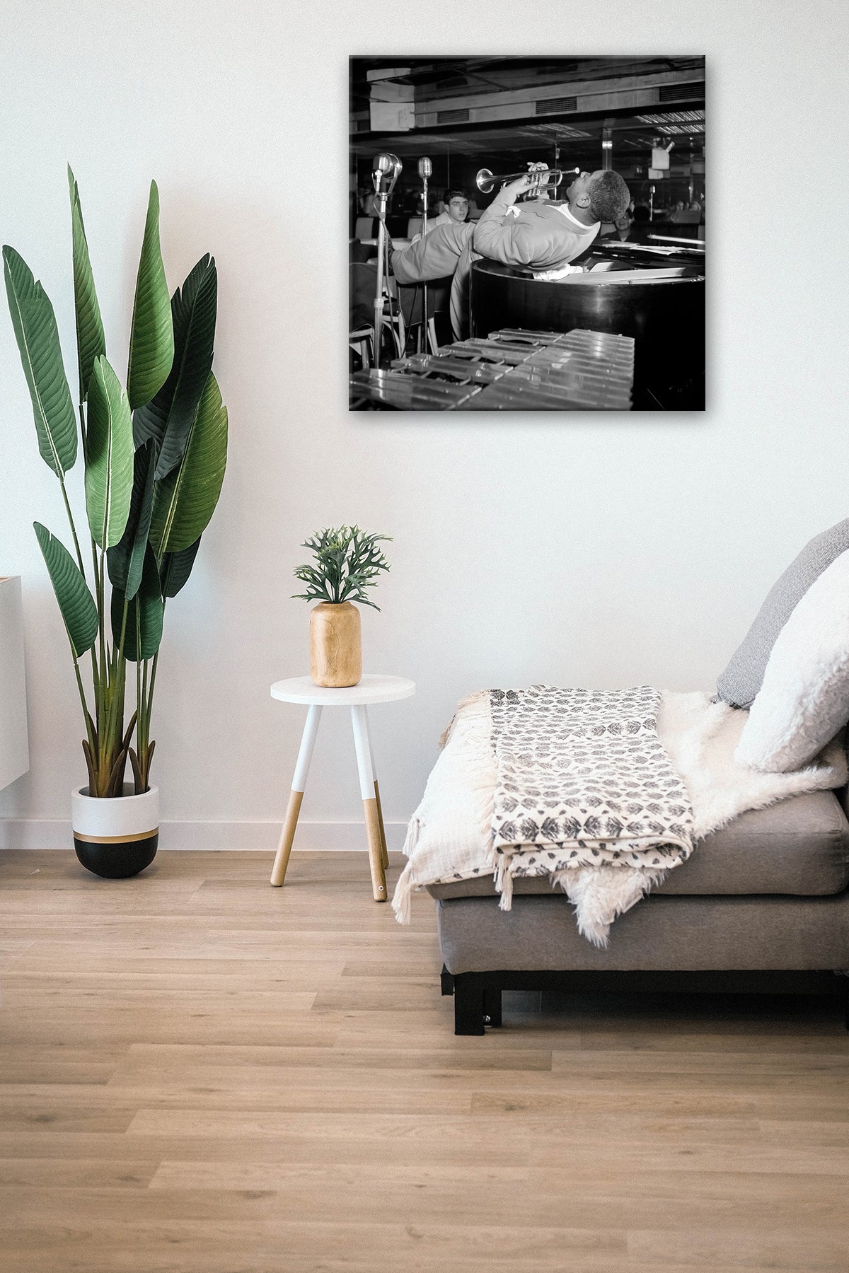 A living room with a canvas print on the wall, featuring a photograph of Dizzy Gillespie