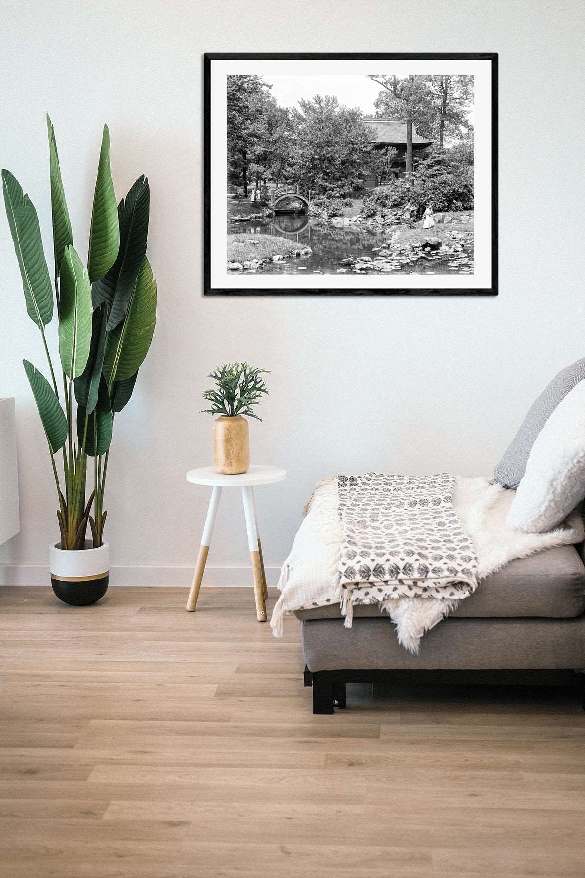 A living room with a framed paper print of a vintage photograph of a Japanese Garden in Philadelphia