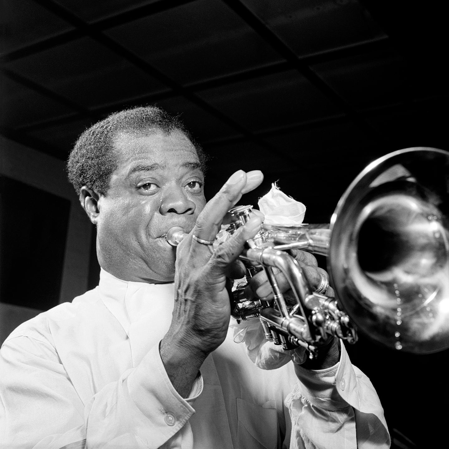 A vintage photogrpah of Louis Armstrong performing at Carnegie Hall