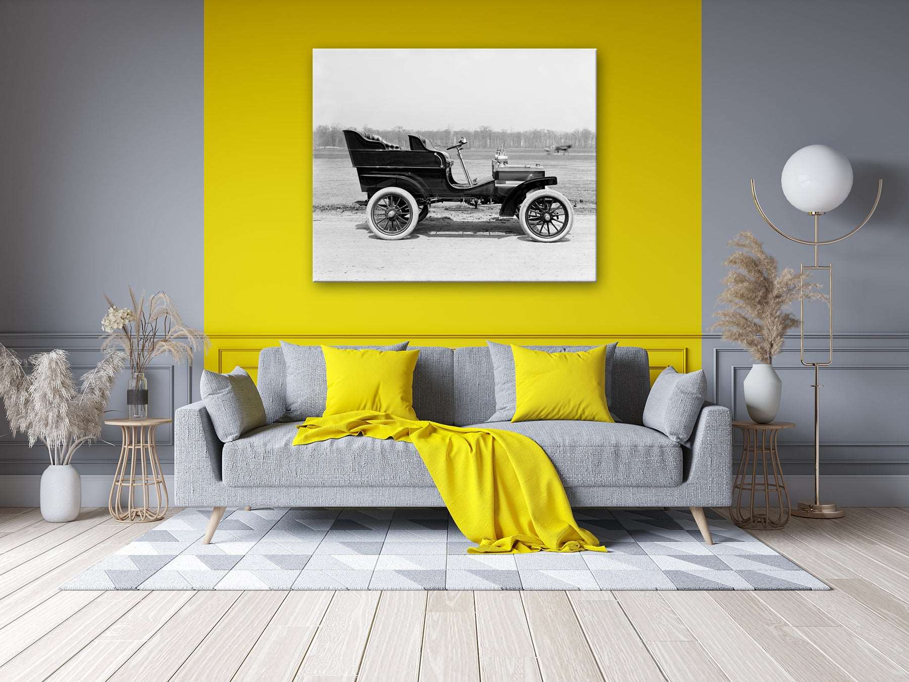 A brightly colored living room with a canvas print on the wall, featuring a vintage photograph of a car
