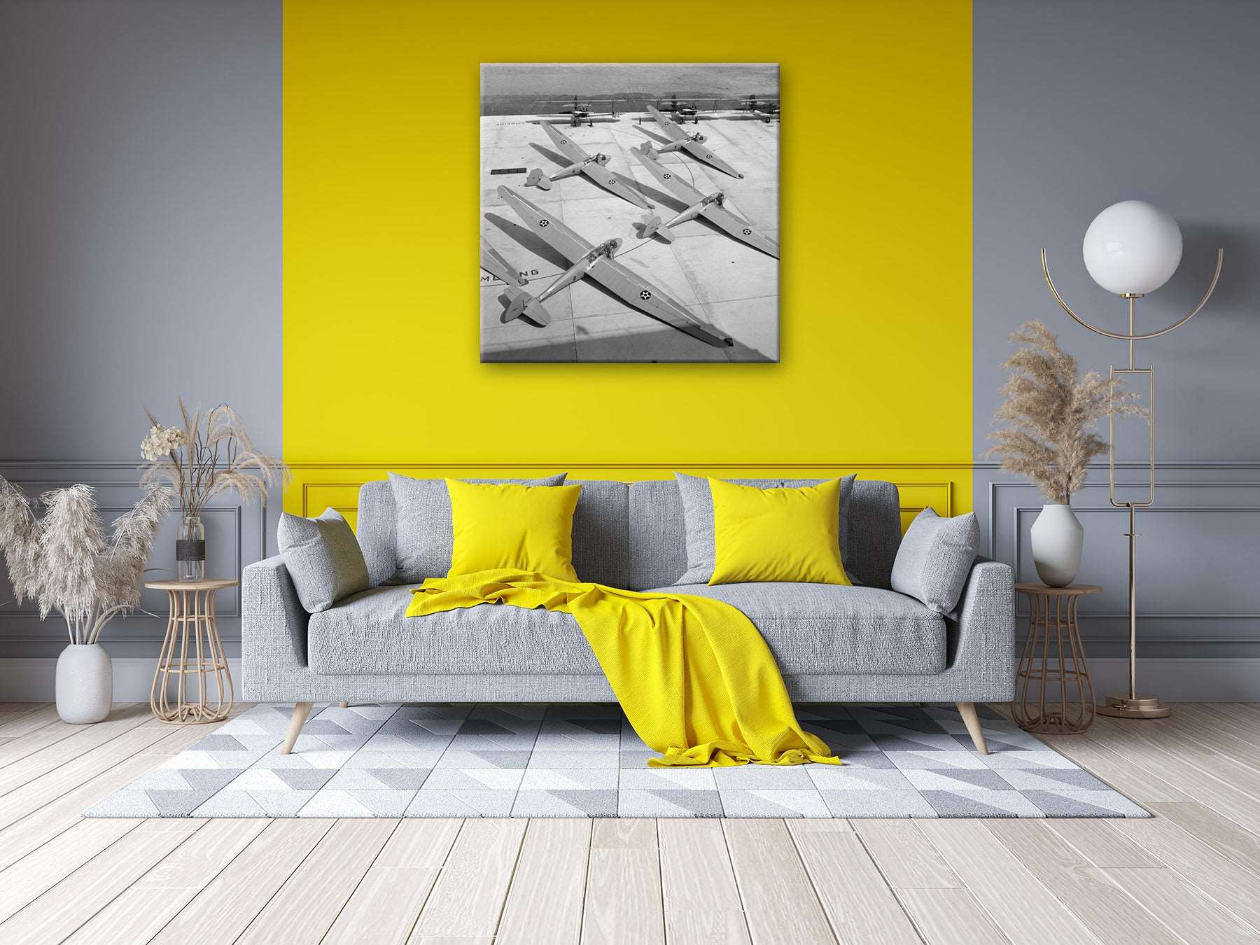 A photo of a living room with a canvas print hanging on a yellow wall