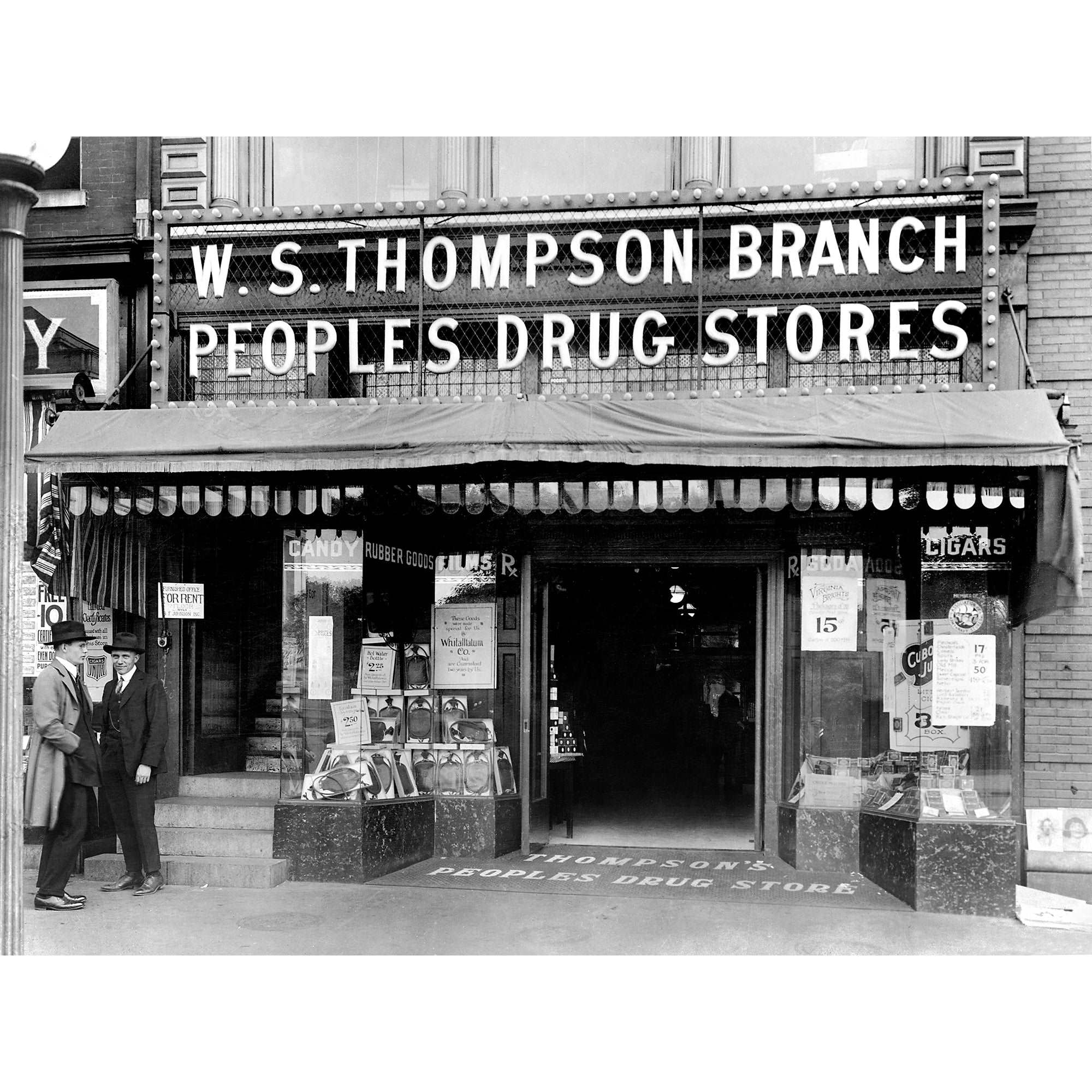 A vintage photograph of two men standing outside of the People's Drug Store in Washington DC