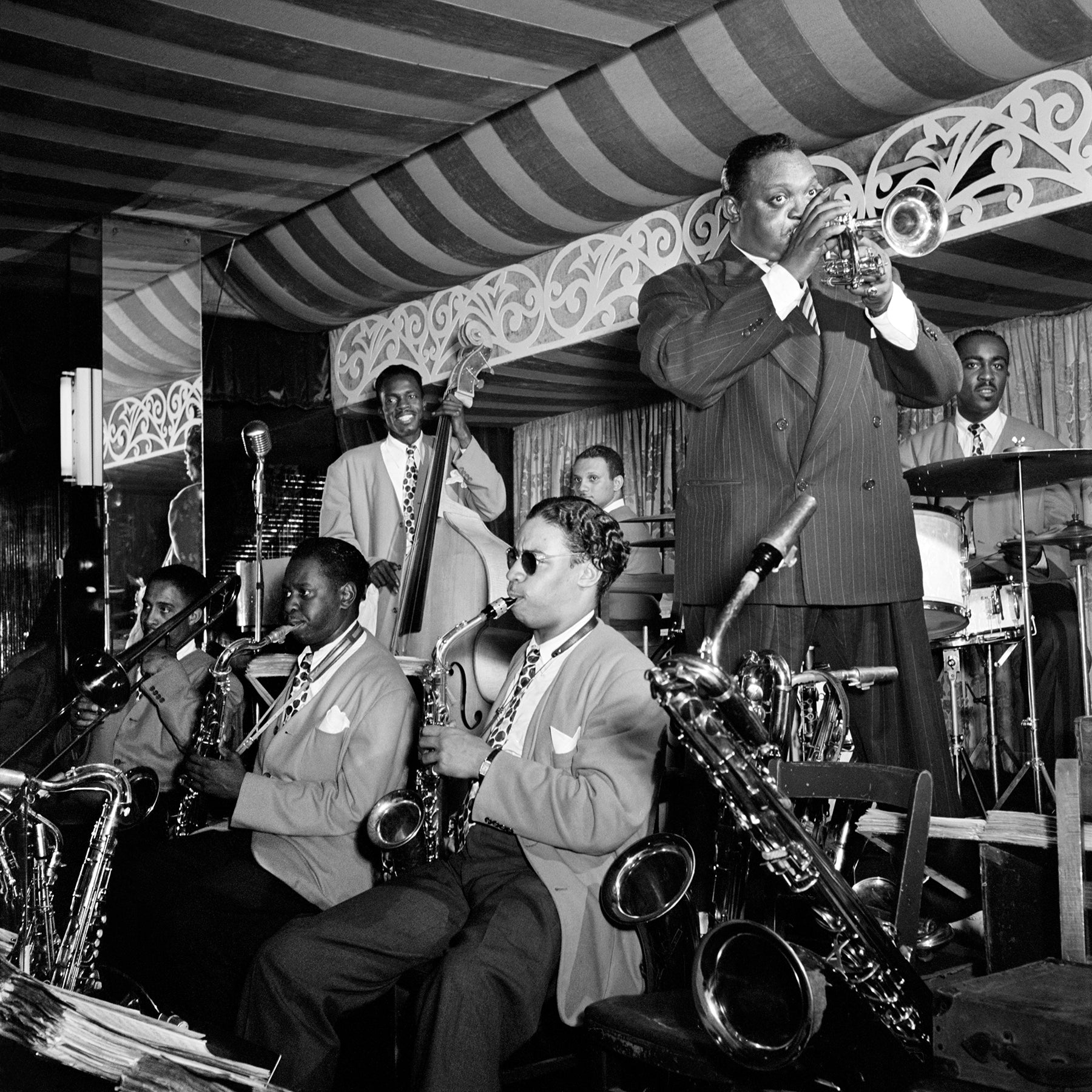 A vintage photograph of Rex William Stewart performing with a group