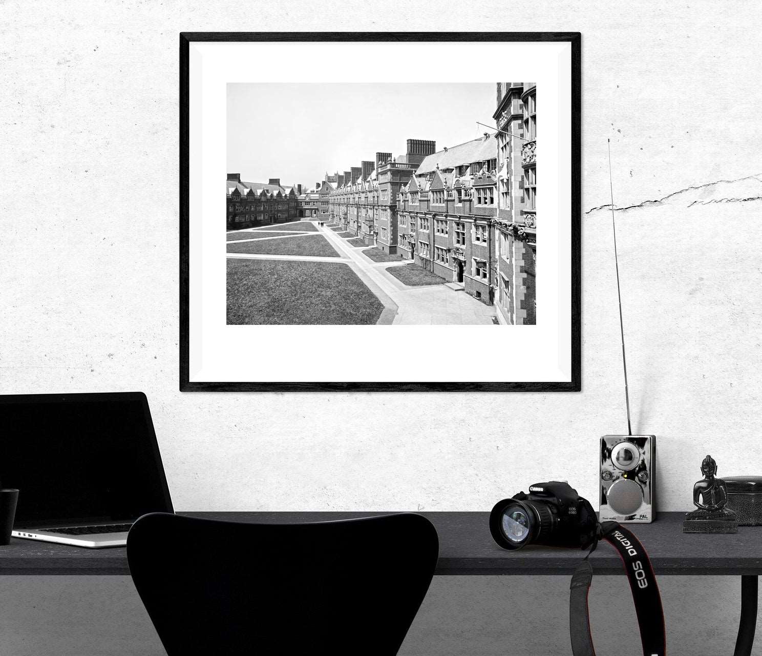 A framed paper print of a University of Pennsylvania photograph, hanging above a desk