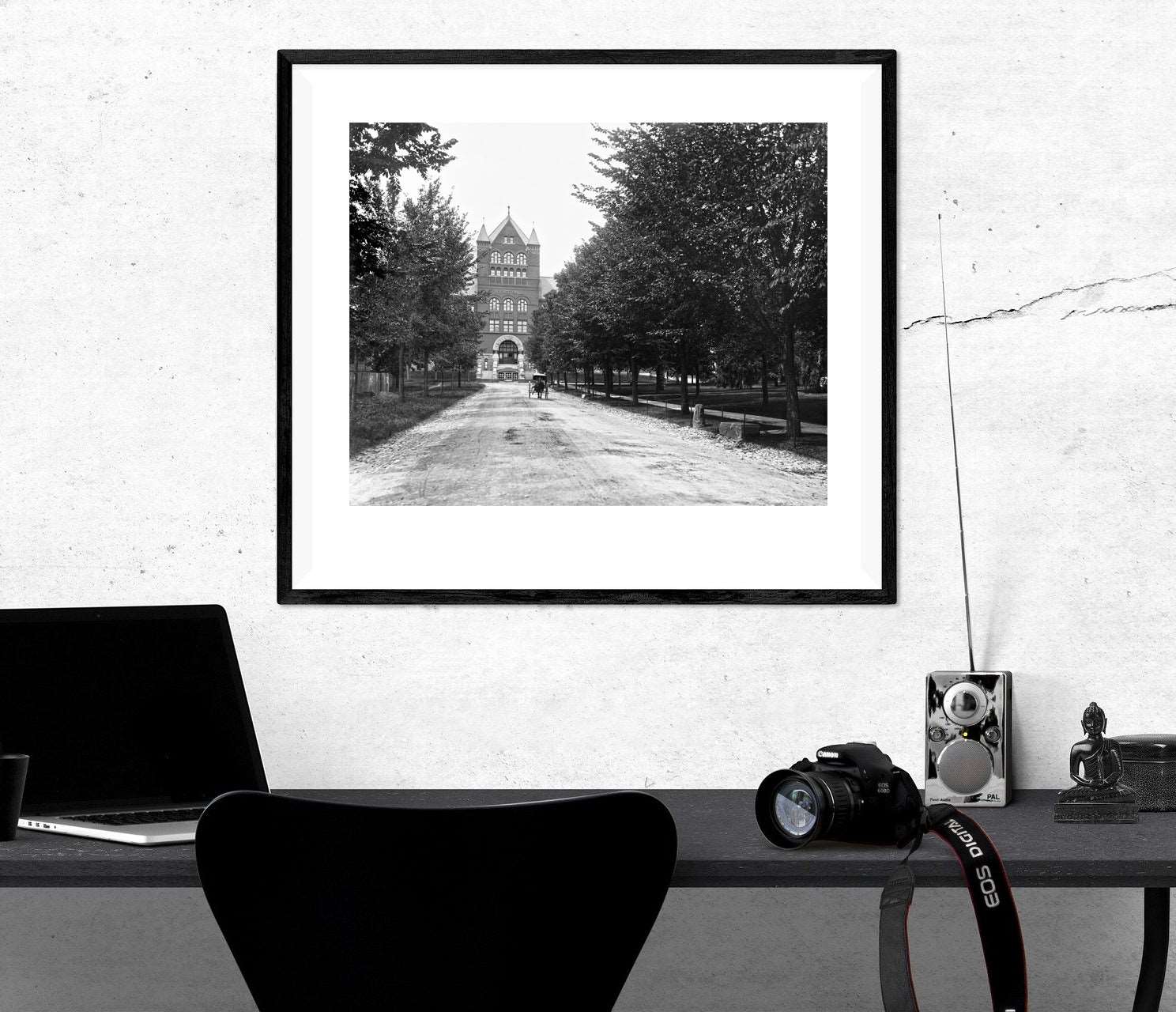 An archival, framed paper print of a restored vintage photograph of the University of Wisconsin, hanging above a desk