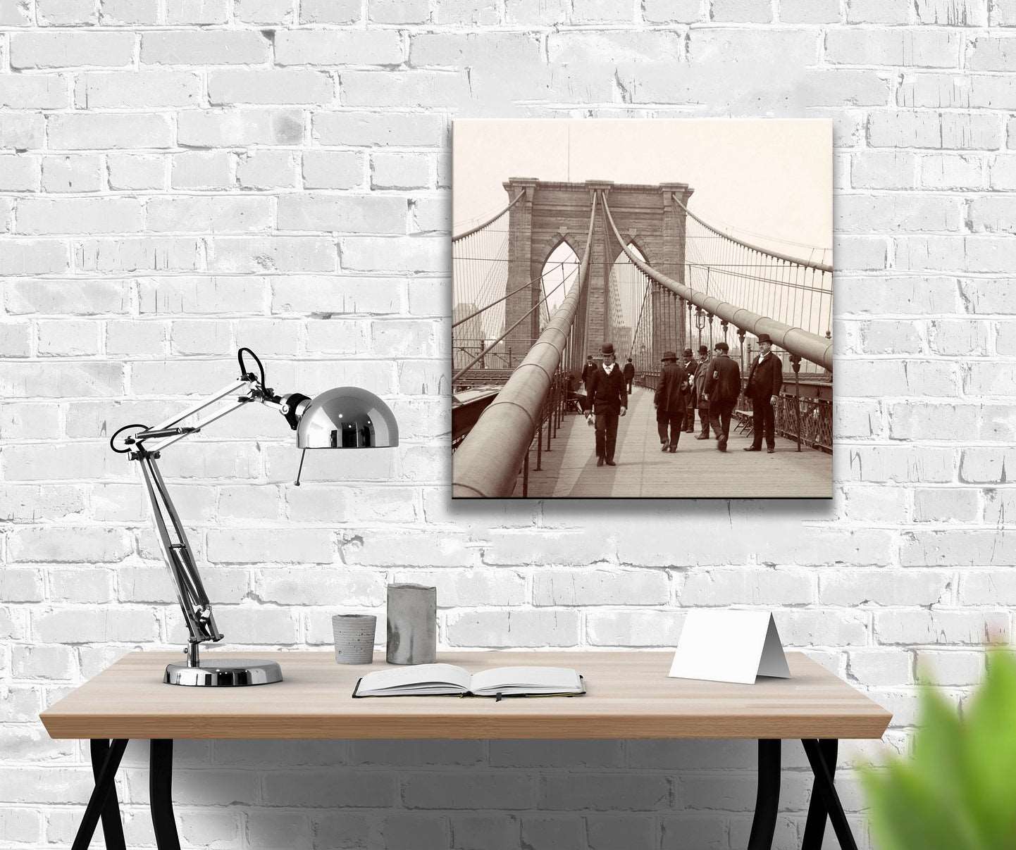 A digitally rendered office space with a canvas print of a vintage photo of the brooklyn bridge hanging on a brick wall