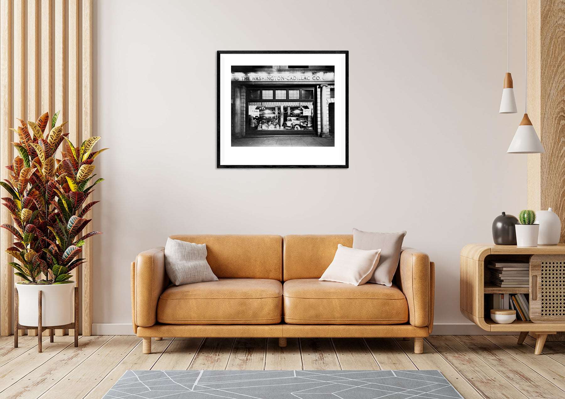 A yellow toned living room with a framed paper print hanging above the couch