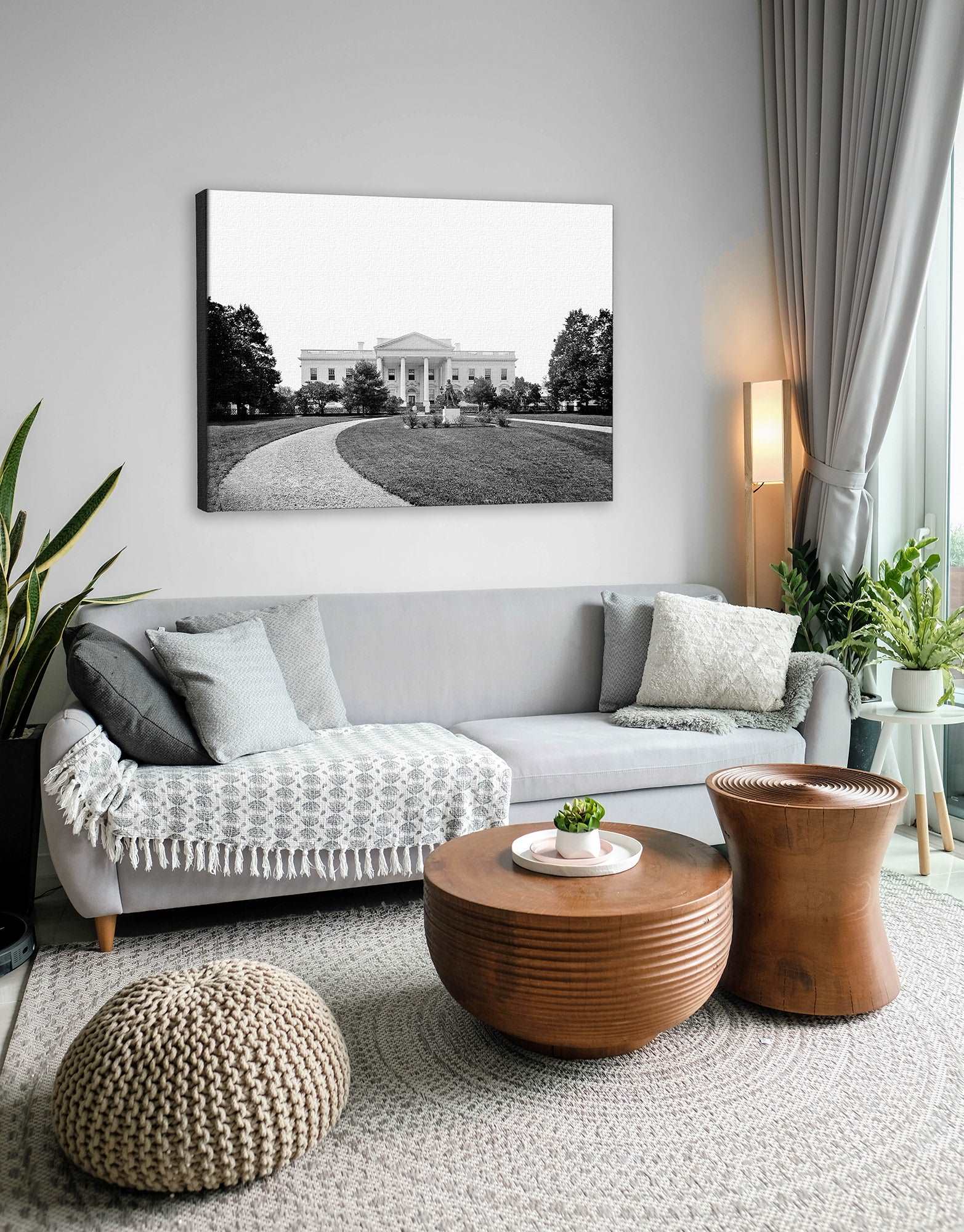A photograph of a living room with a canvas print of a photograph of The White House above the couch