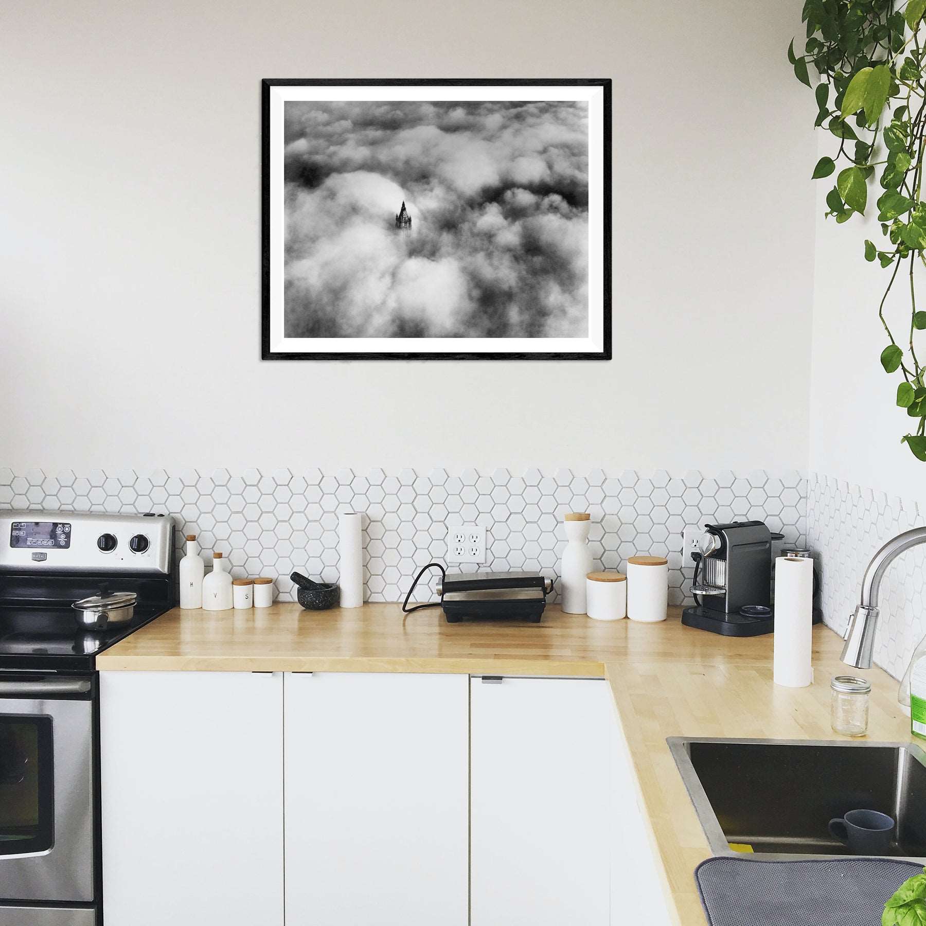 A paper print of vintage photograph of Woolworth Tower, NYC, framed and hanging in a modern kitchen