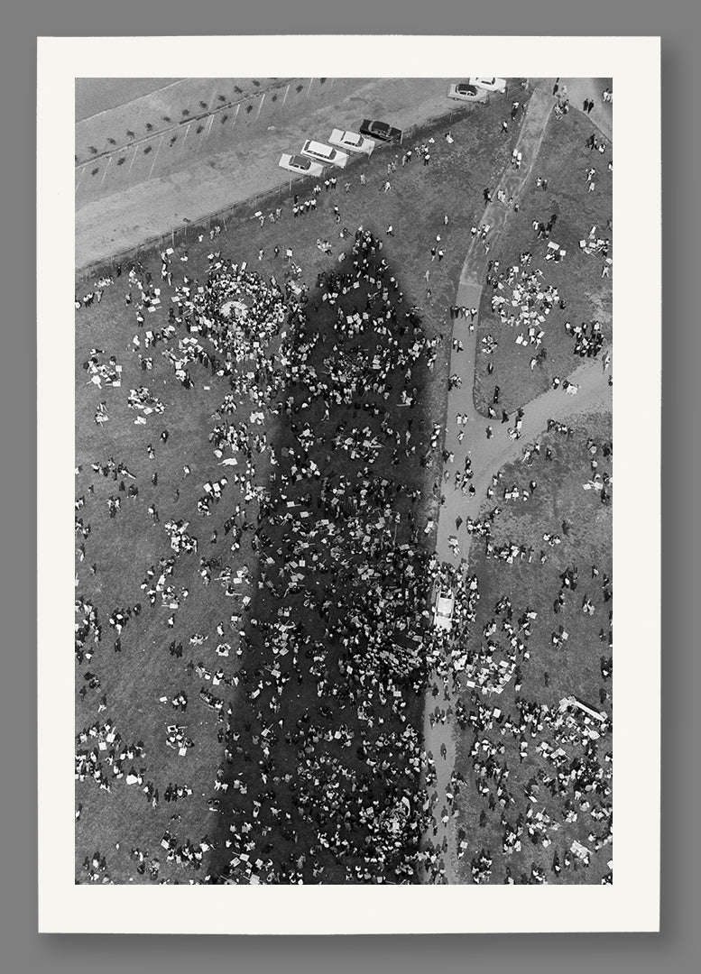A paper print of a vintage photo of March on Washington attendees in the shadow of the Washington Monument. 