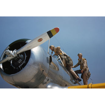 Two people on a vintage airplane with a clear blue sky background