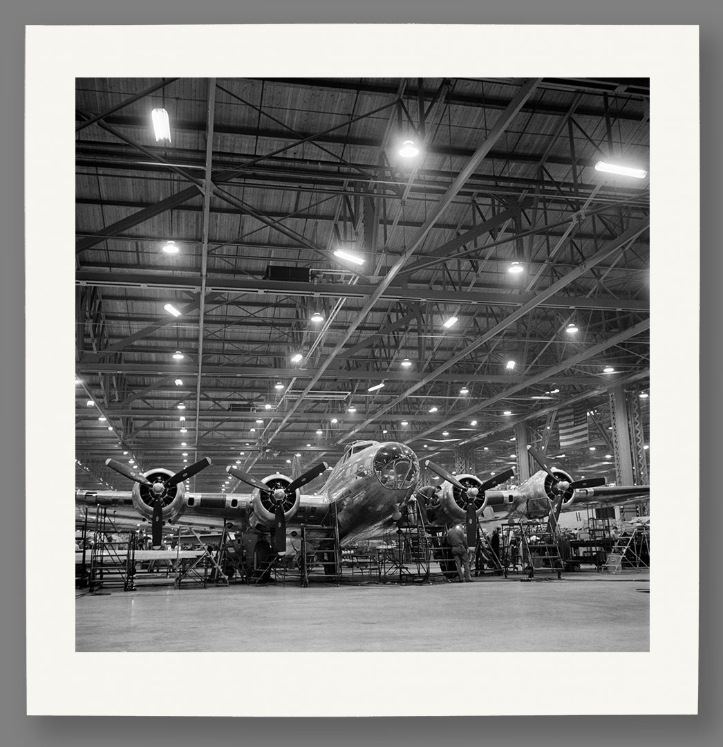 A fine art paper print of a photograph of airplanes in production