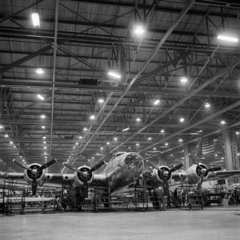 A black and white vintage photograph of B-17F bombers in production
