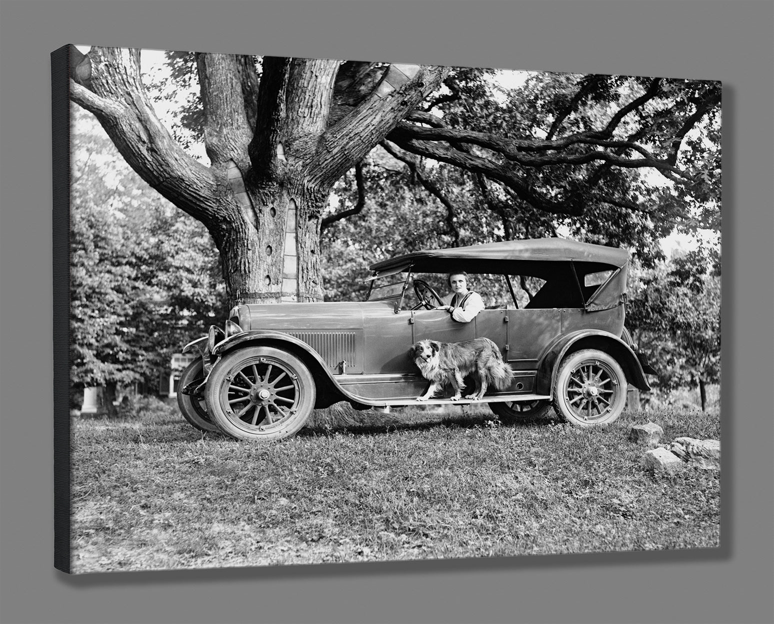 A mockup of a stretched canvas print of a vintage photograph of a woman in a car made by Jordan Motor Car Company