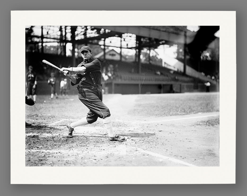Paper print of a vintage black and white photograph of a baseball player in action on a field