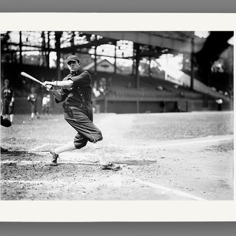 Paper print of a vintage black and white photograph of a baseball player in action on a field