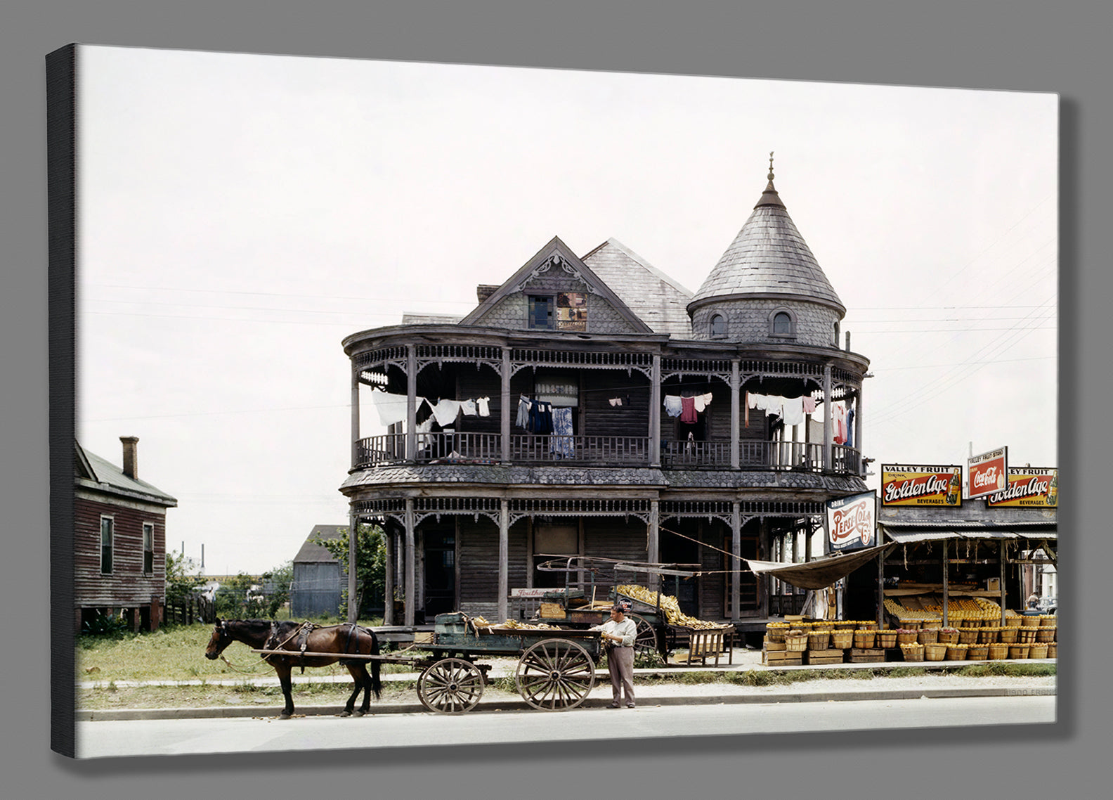 A mockup canvas print of a restored vintage photograph of a house in Houston, Texas with a horse and produce stand