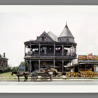 A mockup paper print of a restored vintage photograph of a house in Houston, Texas with a horse and produce stand