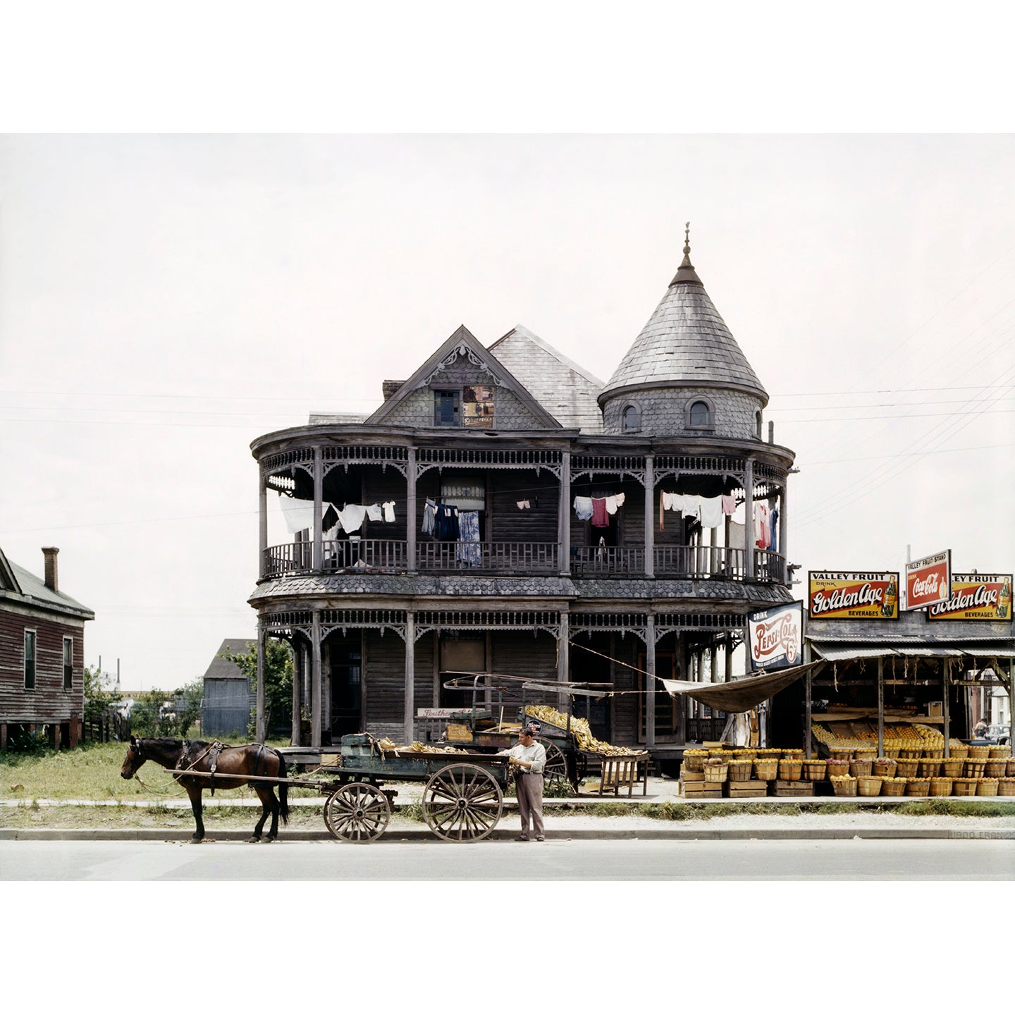 restored vintage photograph of a house in Houston, Texas with a horse and produce stand