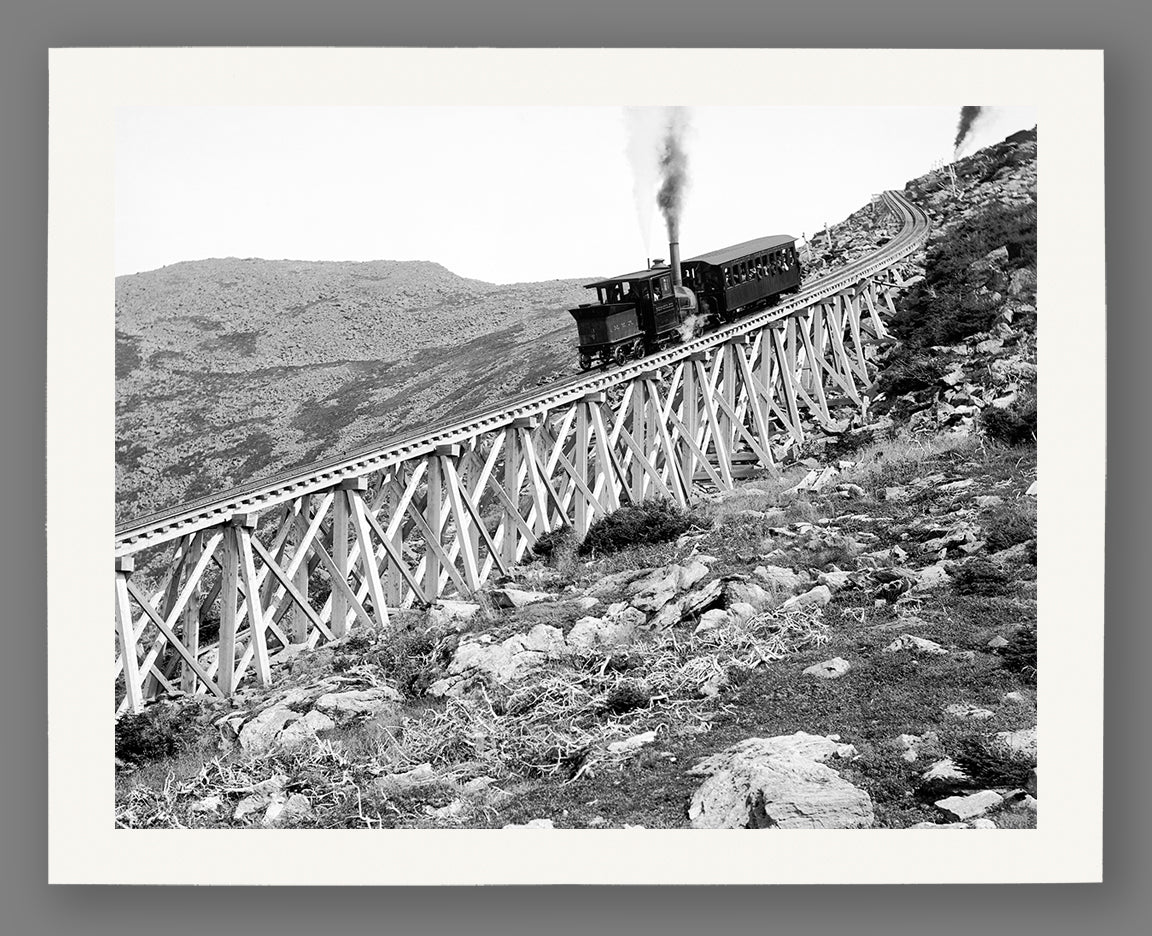 A fine art paper print of a vintage photograph of a train descending the tracks on Mt. Washington