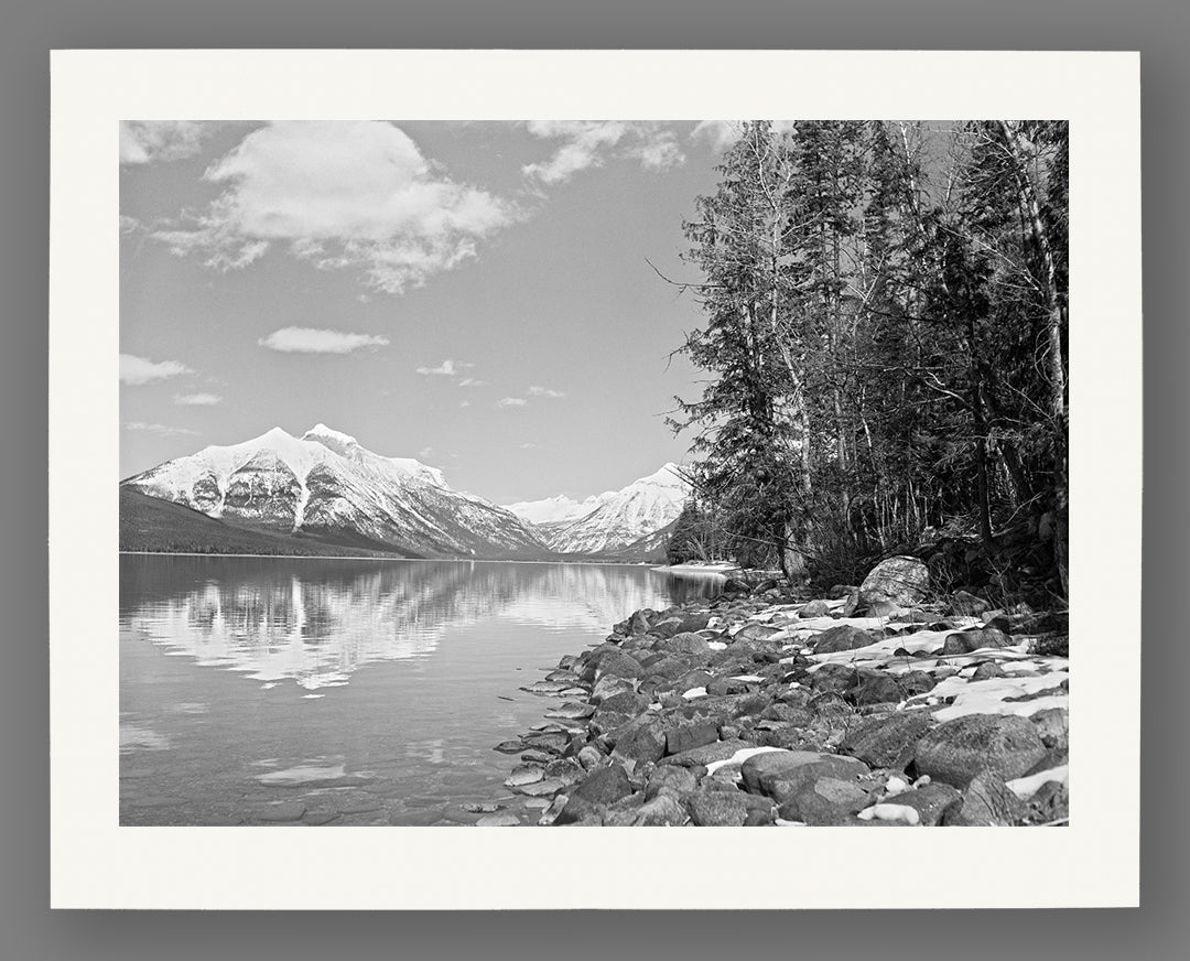 A reproduction print on paper of a vintage photograph of Lake McDonald in Glacier National Park