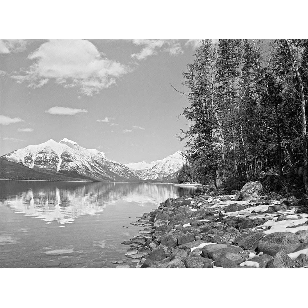 A vintage, black and white photograph of Lake McDonald in Glacier National Park