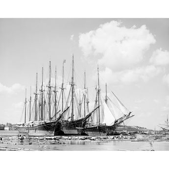 A vintage photograph of three sailing ships docked in Portland, Maine