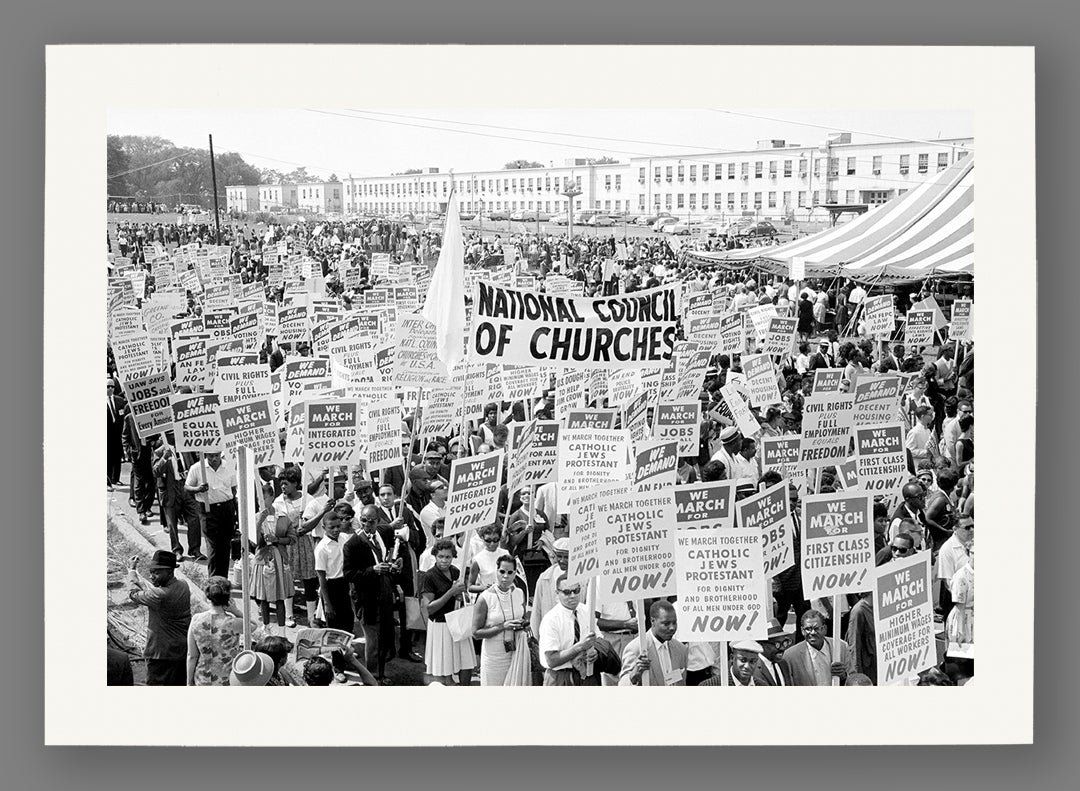 Paper print of a black and white photograph of a large crowd holding signs, with a prominent 'National Council of Churches' sign.