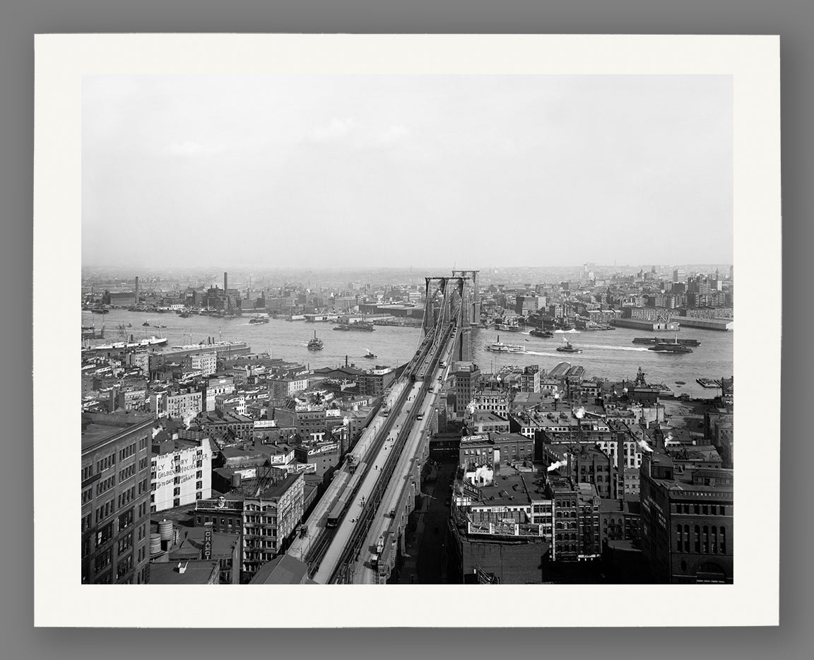 A vintage aerial photograph of the Brooklyn Bridge, printed on paper
