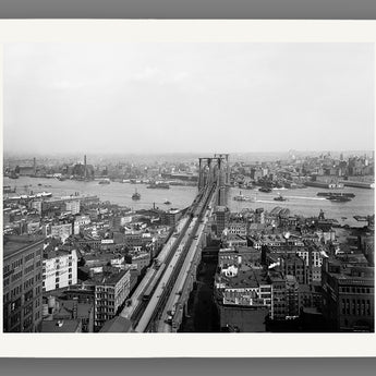 A vintage aerial photograph of the Brooklyn Bridge, printed on paper