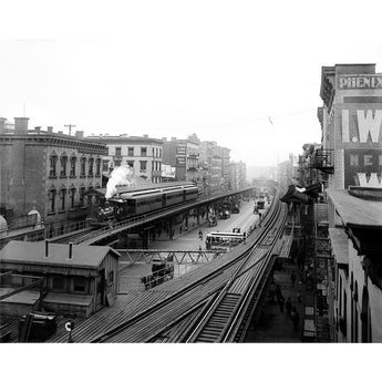 Vintage black and white photograph of a train on elevated tracks in New York City with buildings and street signs.