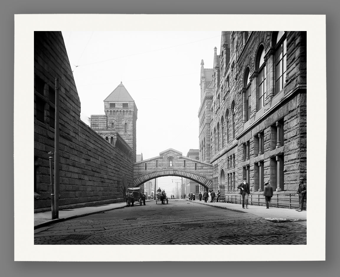 A print on fine art paper of a vintage photograph of a stone bridge over a quiet Pittsburgh street
