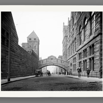 A print on fine art paper of a vintage photograph of a stone bridge over a quiet Pittsburgh street