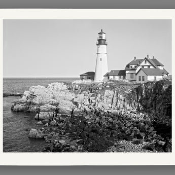 A digital mockup of an archival paper print featuring a historic photograph of the Portland Head Light in Maine