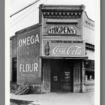 A vintage photograph printed on fine art paper, depicting a storefront in rural Alabama