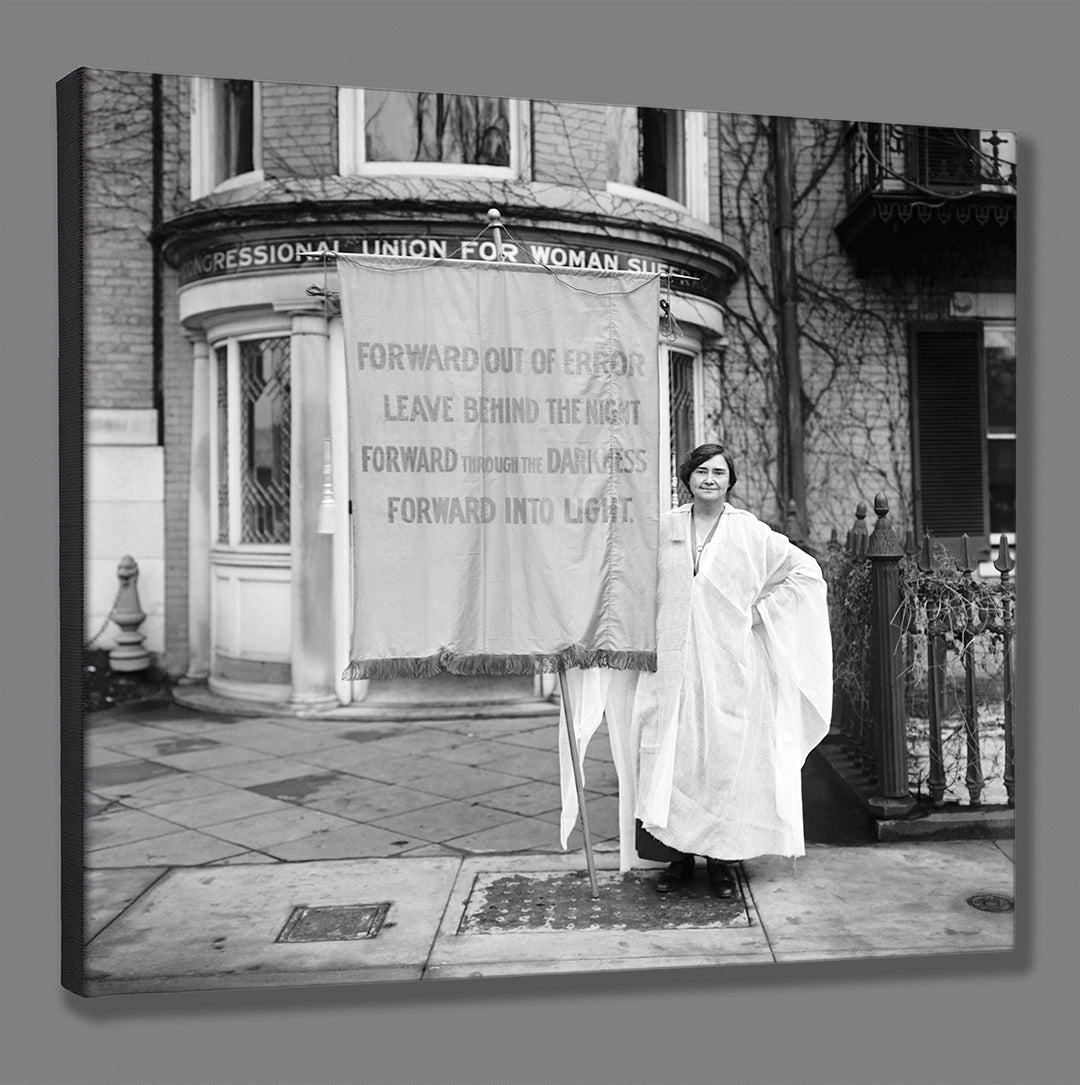 A stretched canvas print of a vintage image of a suffragette holding a banner reading "forward out of error"