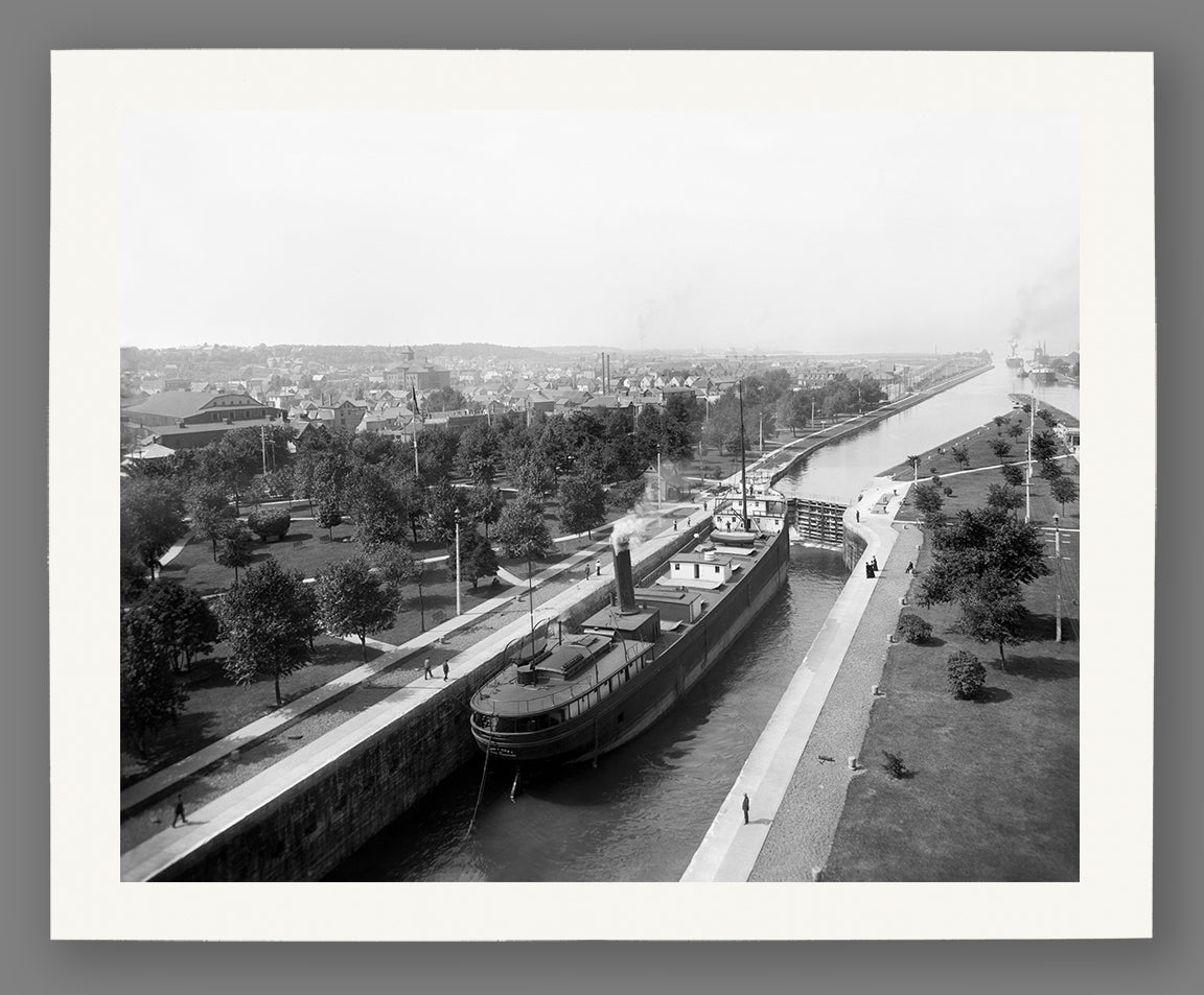A print on fine art paper of a vintage photo of a ship traversing the locks at Sault Ste Marie